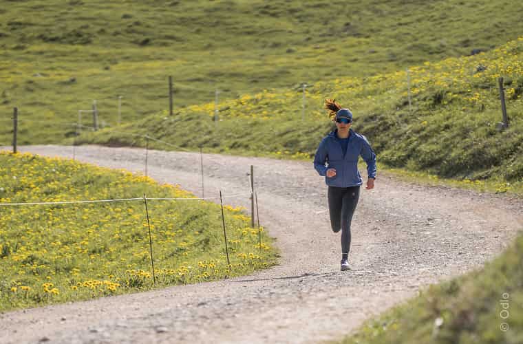Läuferin auf Pfad zwischen Wiesen